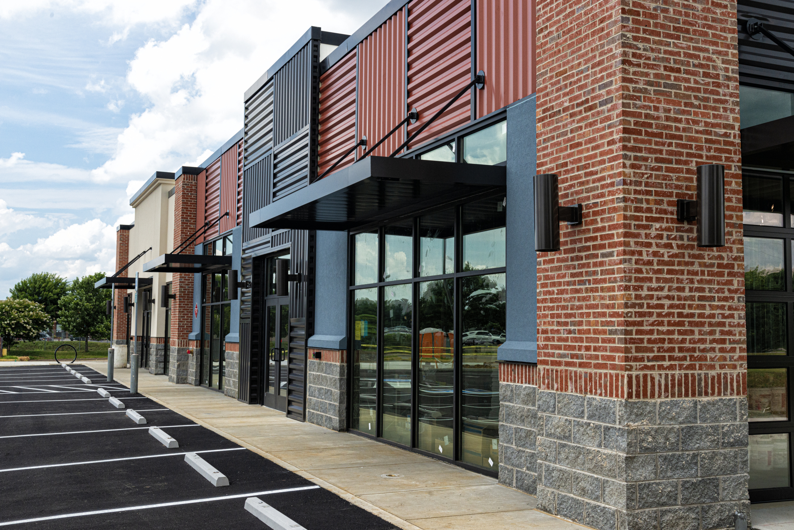 Horizontal shot of a new strip shopping center almost ready to open.